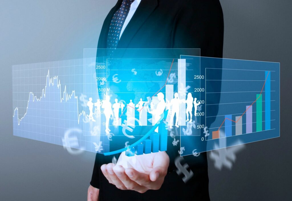 Businessman presenting digital financial data and graphs in his hands.